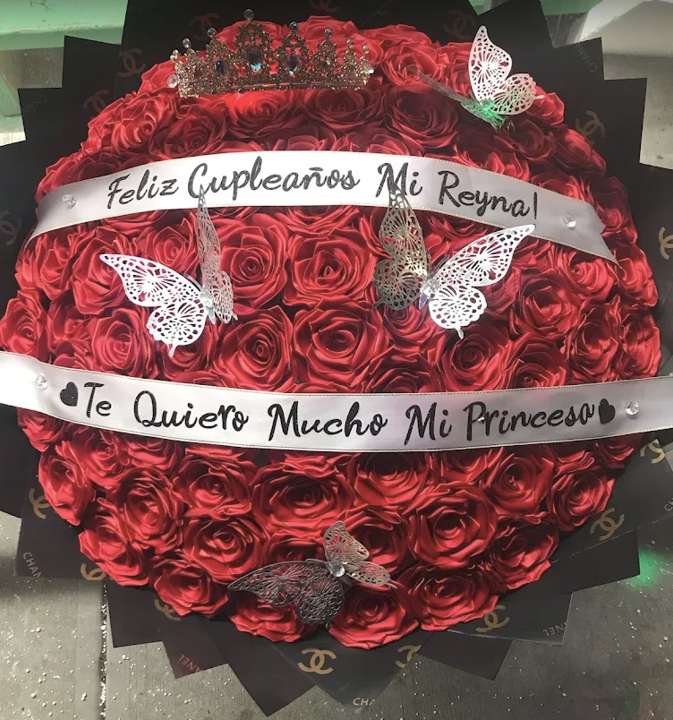 Round red satin rose bouquet with a crown and Feliz Cumpleaños Mi Reyna sash