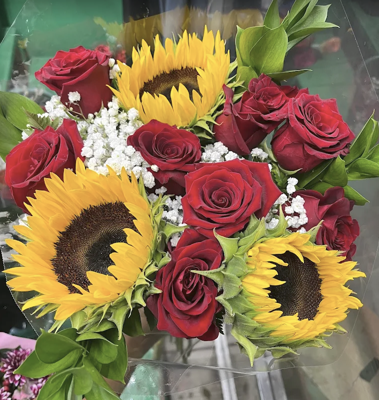 Sunflowers, red roses and baby's breath wrapped as a fresh-cut bouquet
