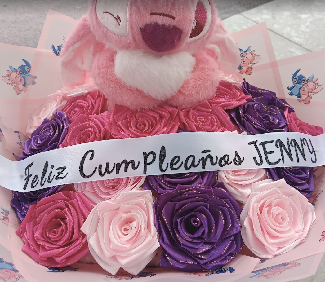 Pink and purple satin roses with a pink plush and Feliz Cumpleaños Jenny sash