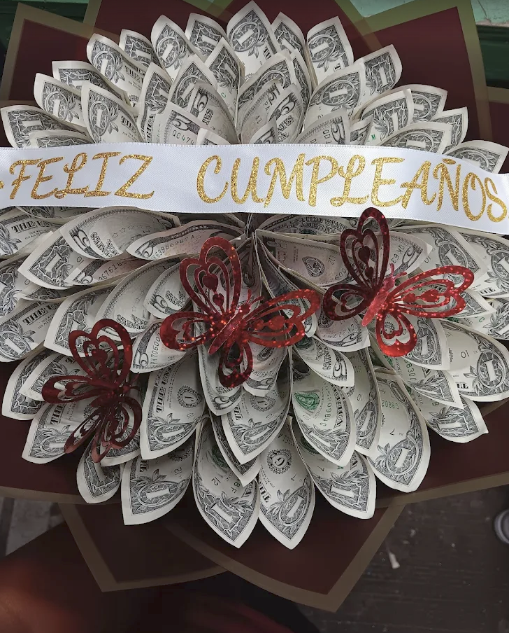 Money bouquet wreath with a Feliz Cumpleaños sash and butterflies