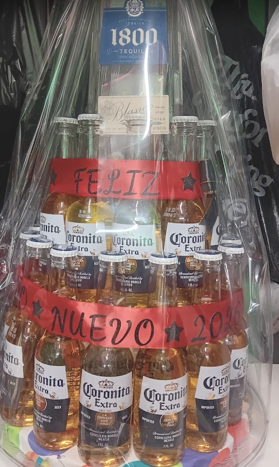 Gift basket of Coronita bottles and tequila wrapped with a Feliz Año Nuevo sash